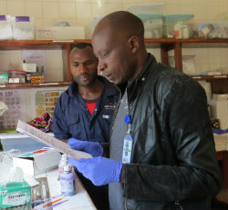Jackson Mbeke working with a colleague in the lab