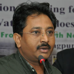Kishor Rithe speaking into a microphone