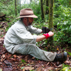 Pablo Perovic adjusting a camera trap in the jungle