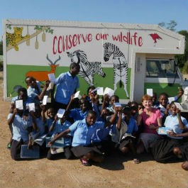 Anna Tolan pictured in front of a conservation bus with a group of young people