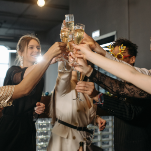 A group of people raising their champagne glasses to each other