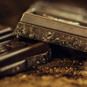 A close-up image of squares of dark chocolate