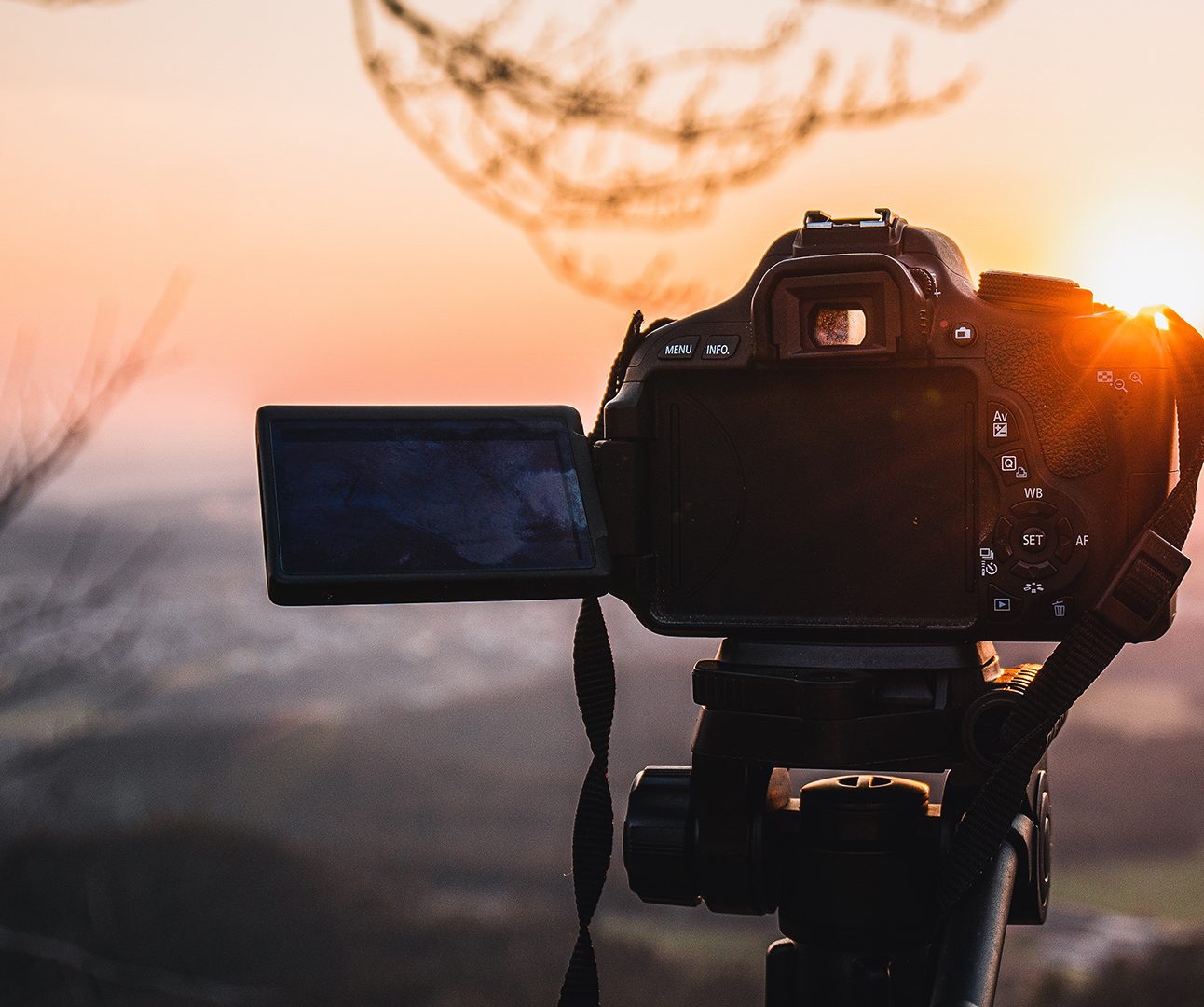 A camera pointing at a sunset landscape