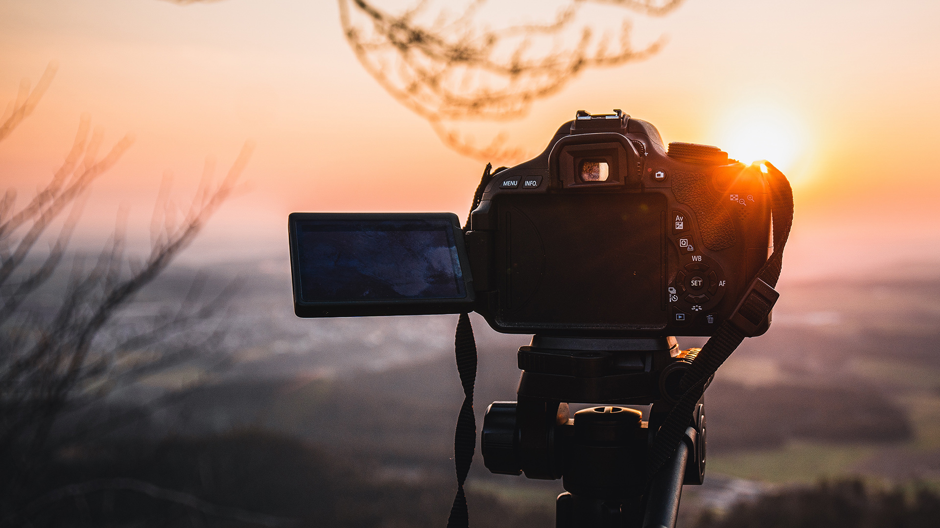 A camera pointing at a sunset landscape