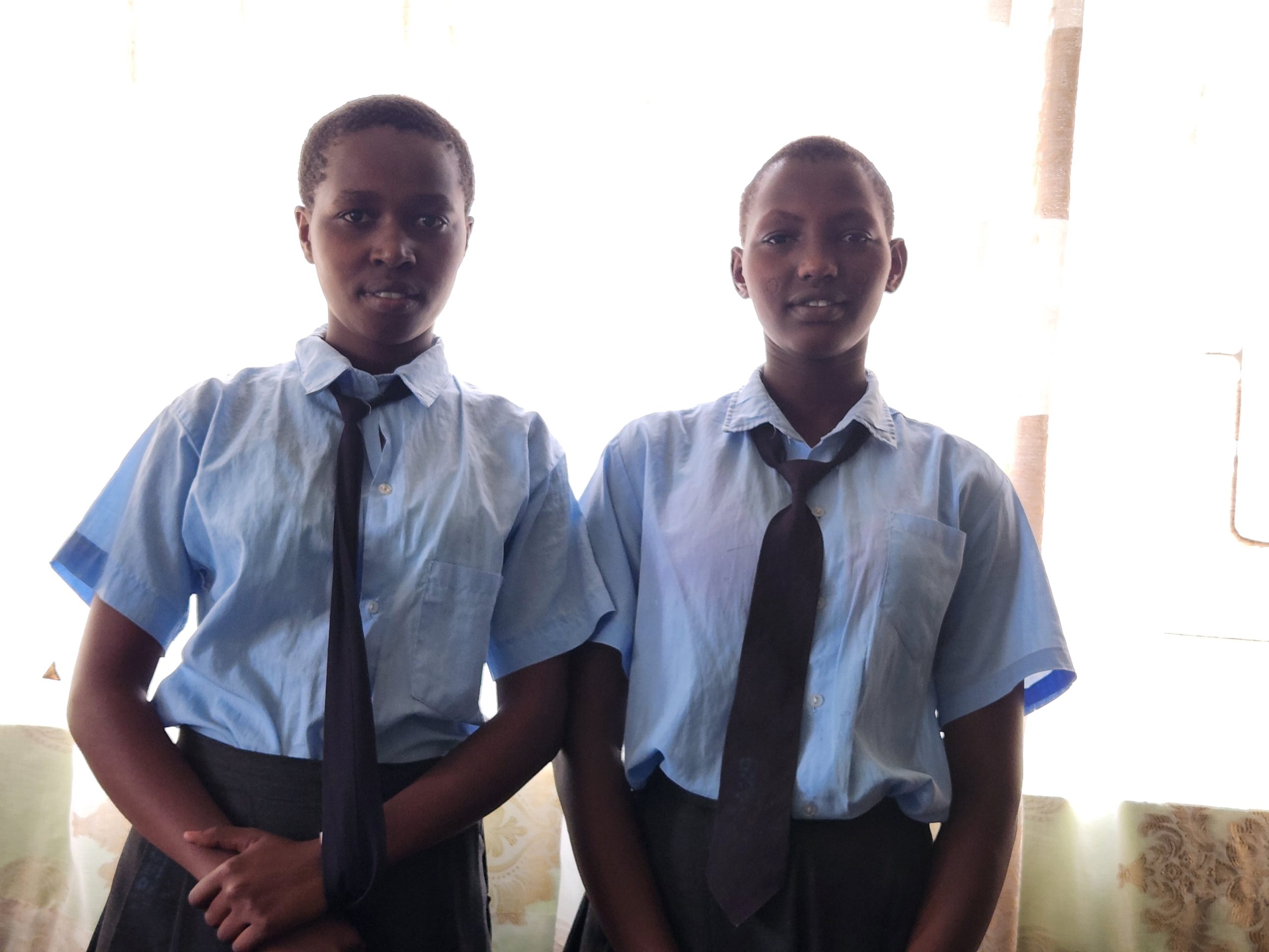 Sarah and Winnie, who Born Free are supporting, in their school uniforms.