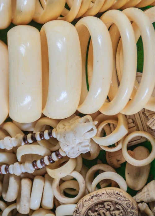A huge pile of ivory items including jewellery, carvings and trinkets