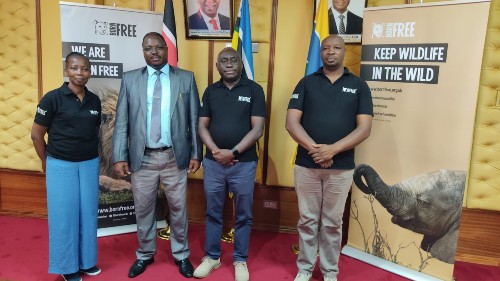 Born Free representatives stand with government officers at the document signing