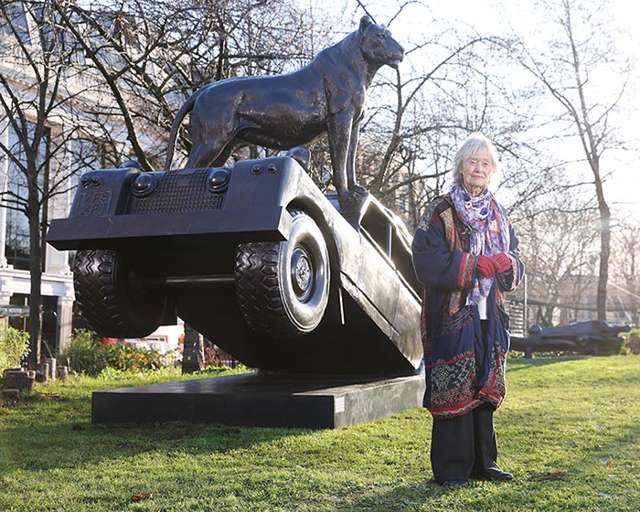 Virginia McKenna stood in front of a bronze lion statue at the Forever Lions exhibition