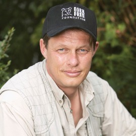 Will Travers wearing a Born Free baseball cap