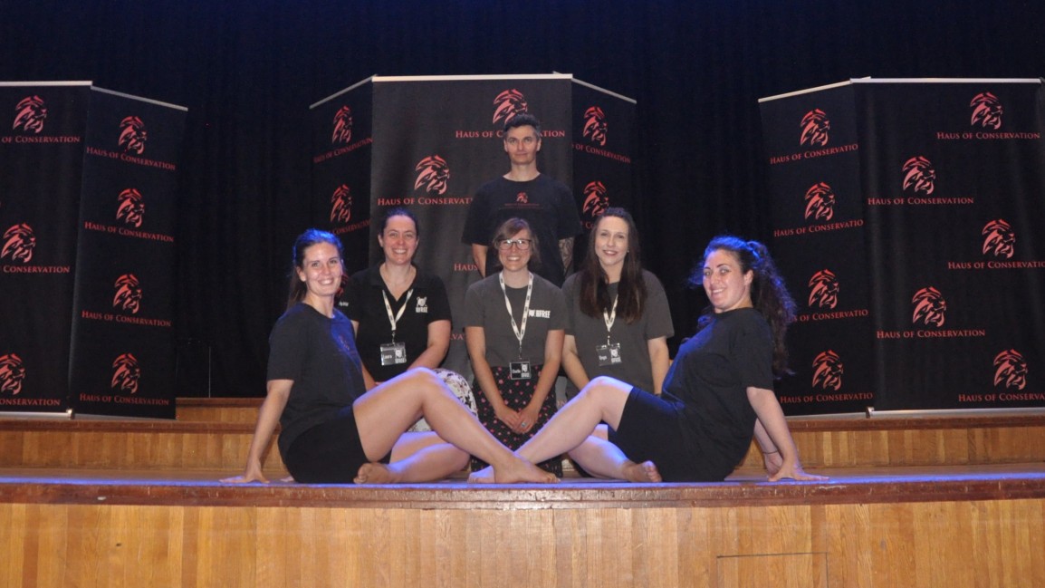 A group of people pose on a stage