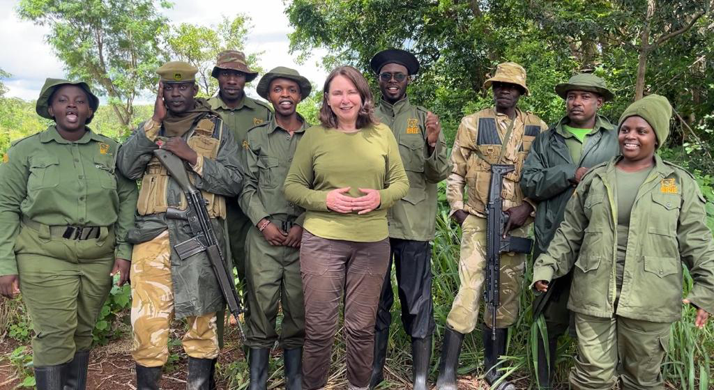 Born Free's Director of Fundraising Katie Arber stands in the middle of the Kenyan de-snaring team