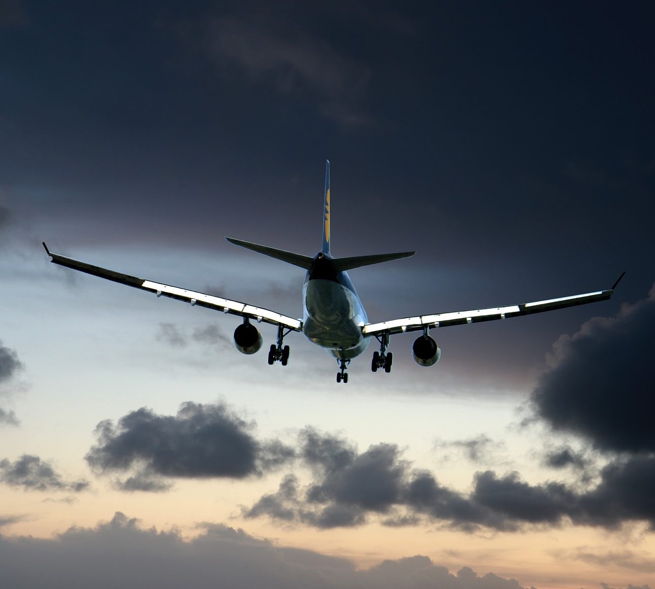 An aeroplane flying in a dark cloudy sky