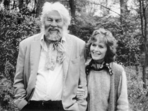 A black and white image of Bill Travers and Virginia McKenna, linking arms and smiling