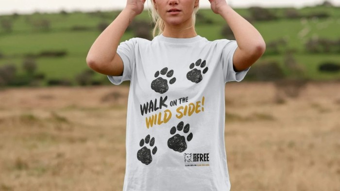 A woman wearing a white Walk on the Wild Side T-shirt