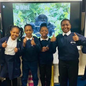 A group of school children give the thumbs up after a Born Free workshop
