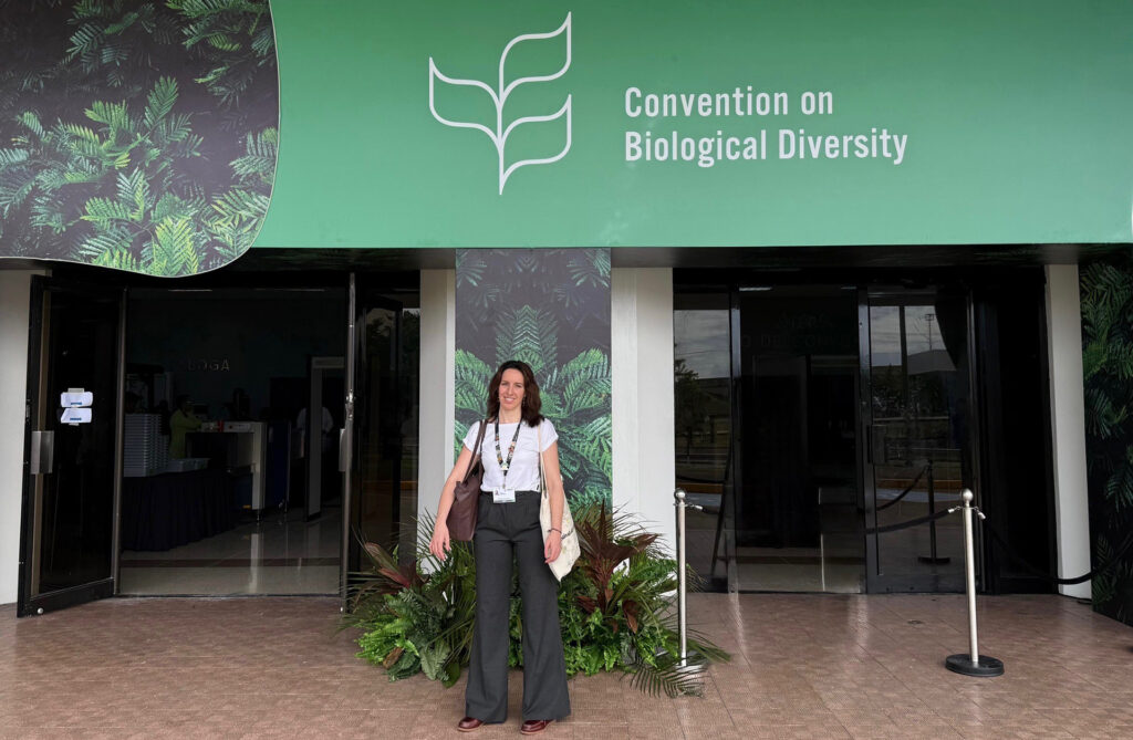 A woman stood outside a building with a prominent banner saying 'convention on Biological Diversity