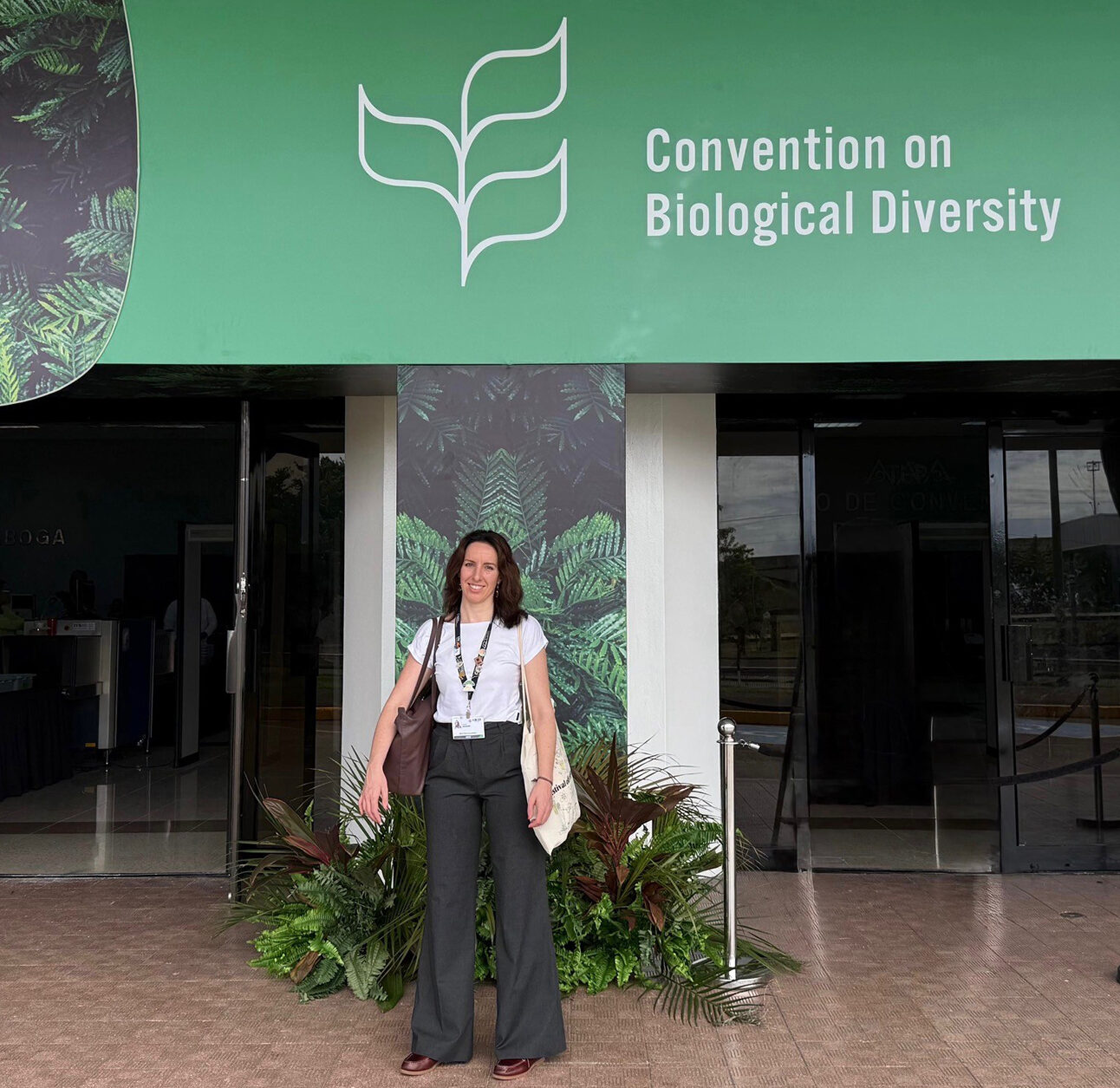 A woman stood outside a building with a prominent banner saying 'convention on Biological Diversity