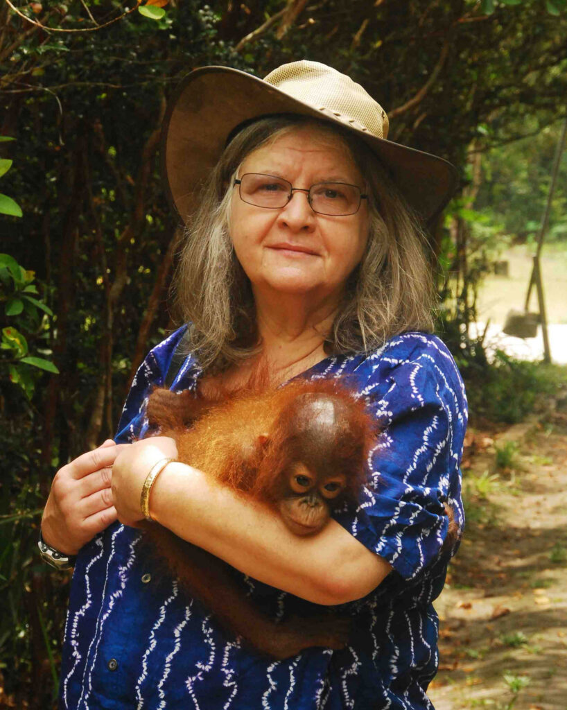 Birutė Galdikas, holding a baby orangutan