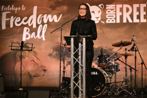 Kirsty Gallacher in a sparkling black dress on stage at the Footsteps to Freedom Ball