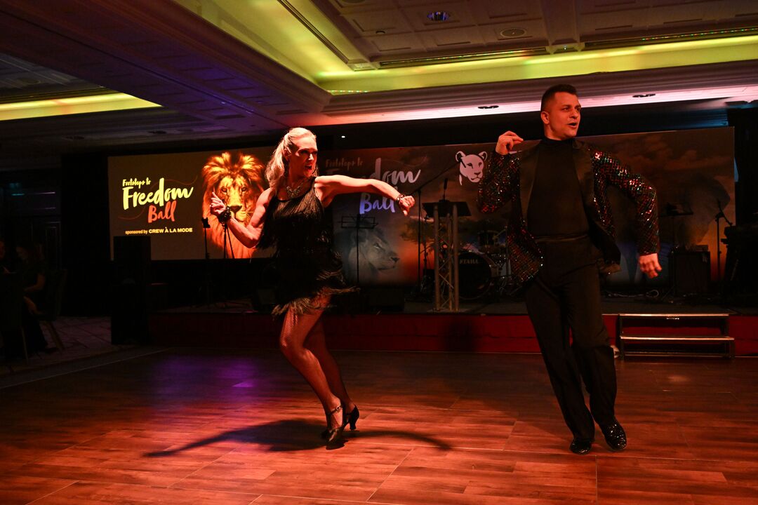 Kristina Rhianoff and Pasha Kovalev both dressed in black, in the middle of a fast-paced dance