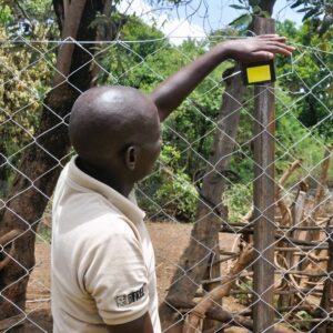 A man installing a predator deterrent light
