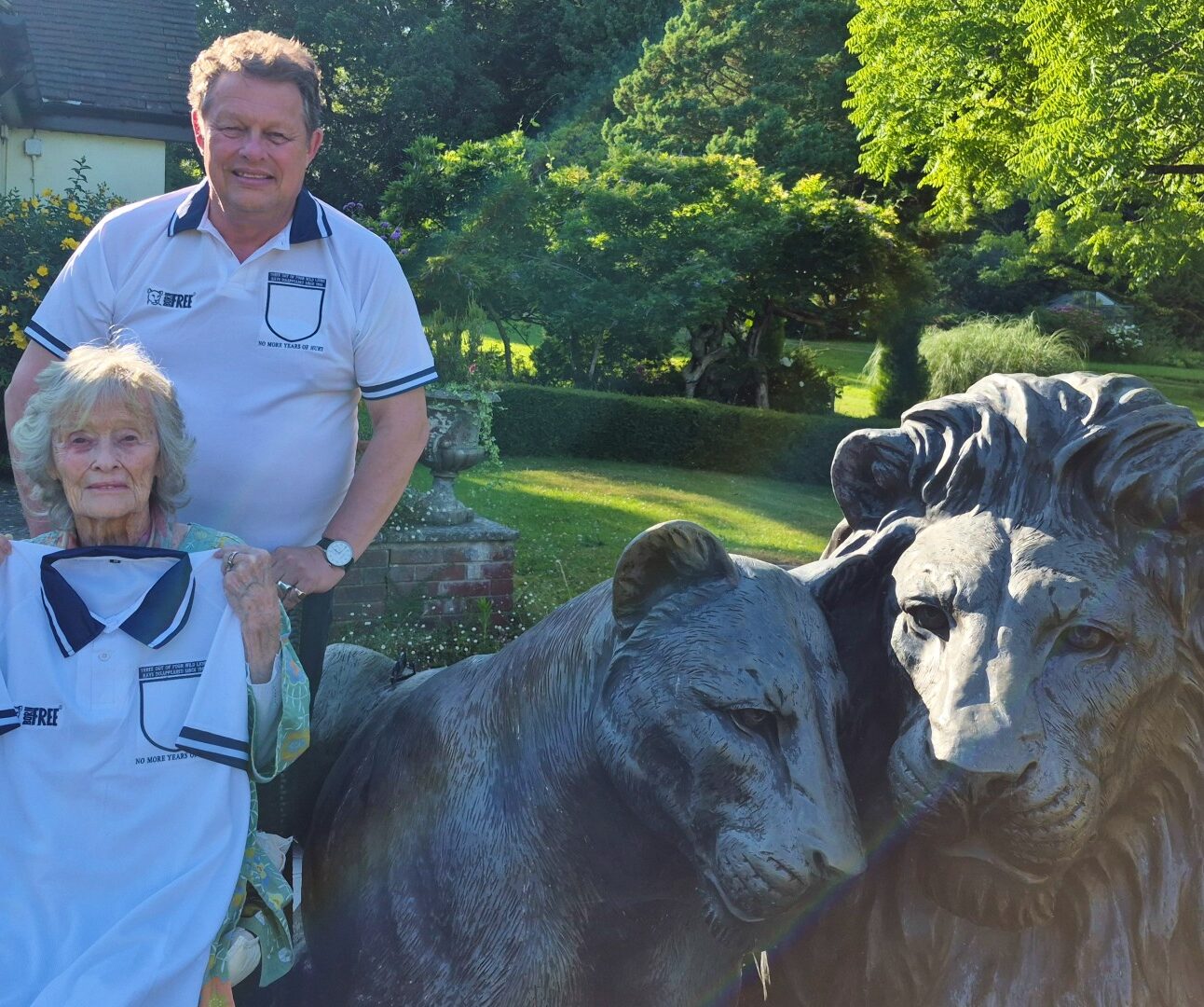 Will Travers OBE and Dame Virginia McKenna modelling mock-up England football shirts with the three lions removed from the badge