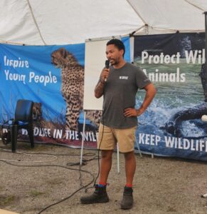 A person speaking into a microphone at a Born Free event